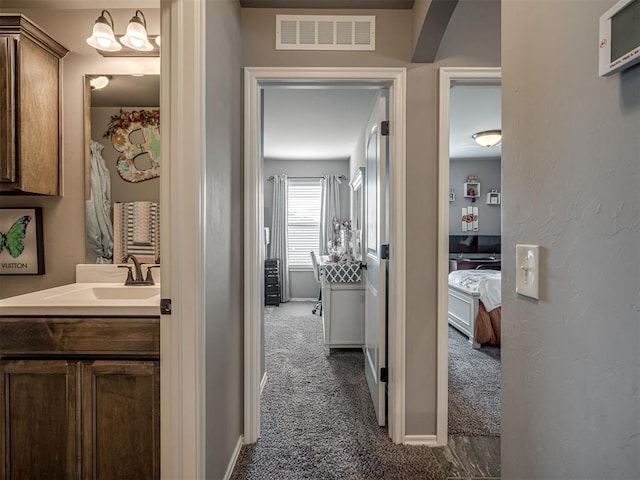 12812 Double V Dr, Piedmont, OK 73078 - hallway with dark carpet and a sink