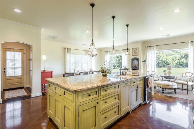 775 Magnolia Ln, Tuttle, OK 73089 - kitchen with ornamental molding, recessed lighting, arched walkways, an island with sink, and hanging light fixtures