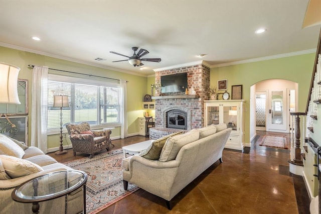 775 Magnolia Ln, Tuttle, OK 73089 - living area with a fireplace, arched walkways, a ceiling fan, ornamental molding, and recessed lighting