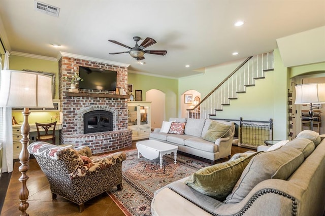 775 Magnolia Ln, Tuttle, OK 73089 - living area featuring arched walkways, ceiling fan, stairs, crown molding, and a fireplace