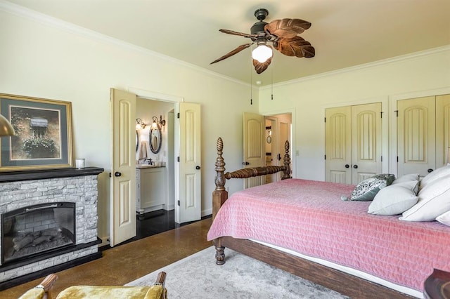 775 Magnolia Ln, Tuttle, OK 73089 - bedroom featuring ornamental molding, two closets, a stone fireplace, and ceiling fan