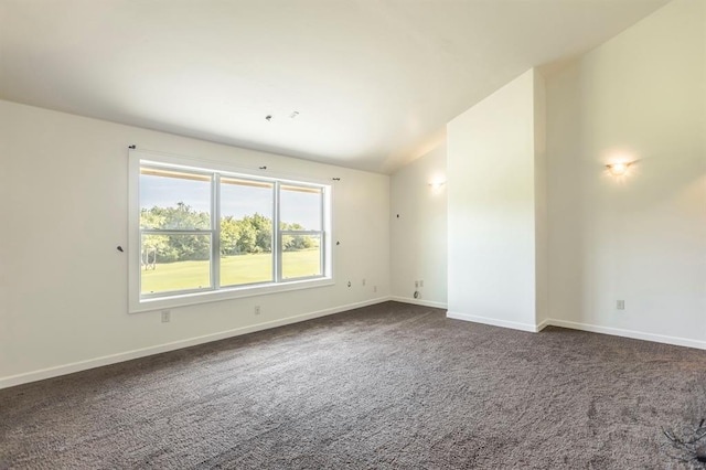 775 Magnolia Ln, Tuttle, OK 73089 - spare room featuring dark carpet and vaulted ceiling