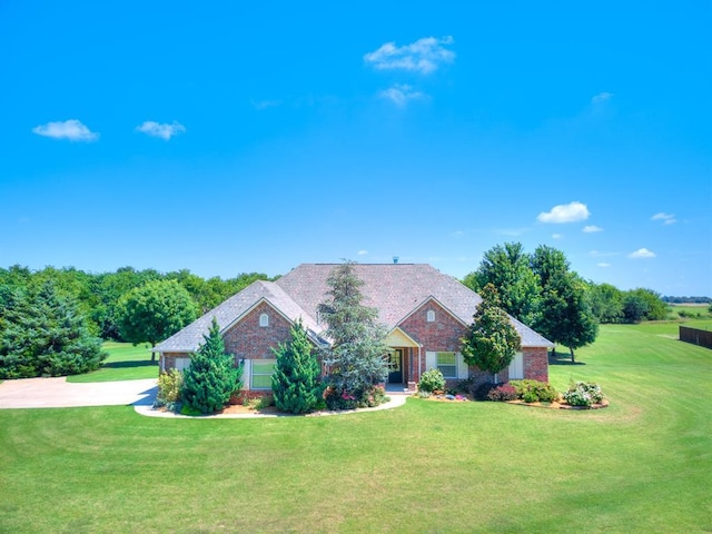 775 Magnolia Ln, Tuttle, OK 73089 - ranch-style house with driveway, a front yard, and brick siding
