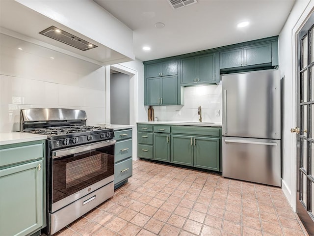 1623 NW 39th St, Oklahoma City, OK 73118 - kitchen featuring stainless steel appliances, green cabinets, tasteful backsplash, light countertops, and recessed lighting