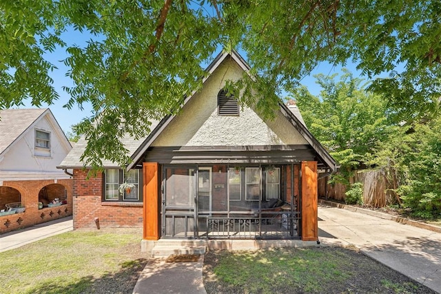1623 NW 39th St, Oklahoma City, OK 73118 - view of front facade with a chimney, brick siding, a sunroom, and roof with shingles