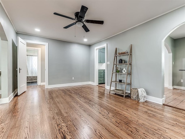 1623 NW 39th St, Oklahoma City, OK 73118 - empty room with arched walkways, ceiling fan, wood finished floors, ornamental molding, and recessed lighting
