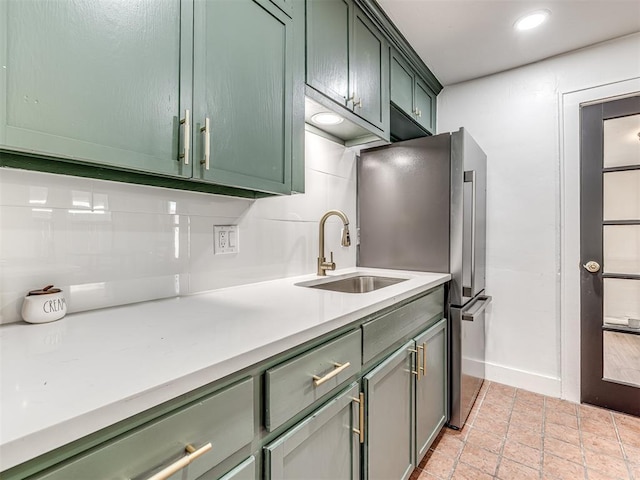 1623 NW 39th St, Oklahoma City, OK 73118 - kitchen featuring green cabinets, light countertops, freestanding refrigerator, light stone finish flooring, and recessed lighting