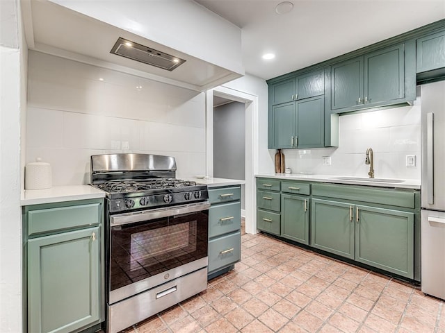 1623 NW 39th St, Oklahoma City, OK 73118 - kitchen featuring appliances with stainless steel finishes, green cabinets, tasteful backsplash, light countertops, and recessed lighting