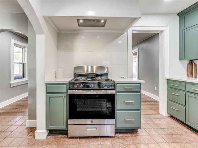 1623 NW 39th St, Oklahoma City, OK 73118 - kitchen featuring green cabinets, stainless steel range with gas cooktop, arched walkways, and light countertops