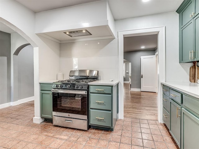 1623 NW 39th St, Oklahoma City, OK 73118 - kitchen featuring green cabinetry, stainless steel gas range, and arched walkways