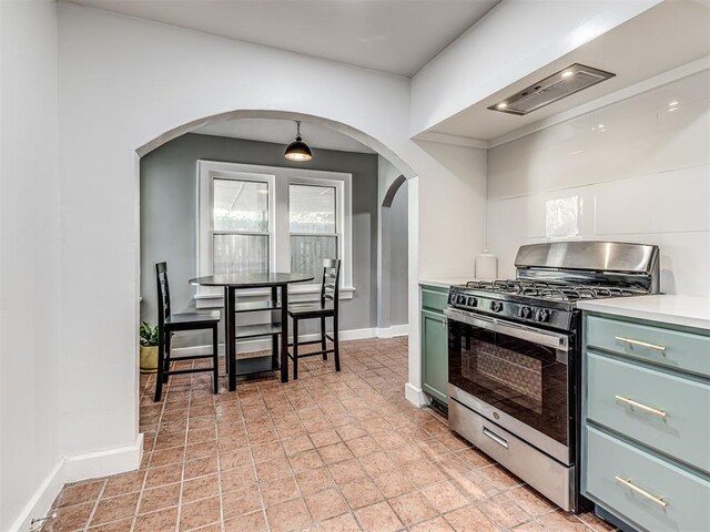 1623 NW 39th St, Oklahoma City, OK 73118 - kitchen featuring stainless steel gas range, green cabinets, arched walkways, and light countertops
