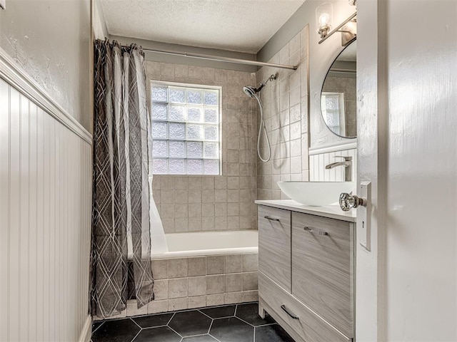 1623 NW 39th St, Oklahoma City, OK 73118 - bathroom featuring tiled shower / bath, tile patterned floors, vanity, and a textured ceiling