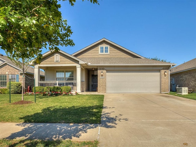 3529 Slate River Dr, Yukon, OK 73099 - view of front of property featuring brick siding, driveway, a front yard, and a porch