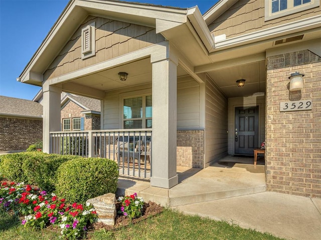 3529 Slate River Dr, Yukon, OK 73099 - doorway to property featuring a porch and brick siding
