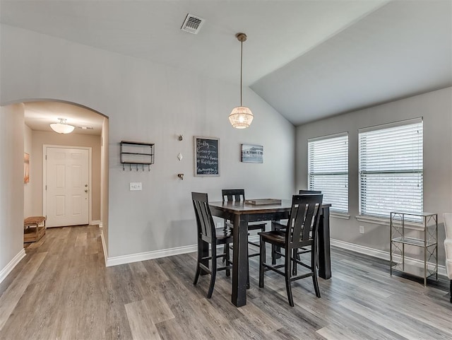 3529 Slate River Dr, Yukon, OK 73099 - dining room with arched walkways, wood finished floors, and lofted ceiling
