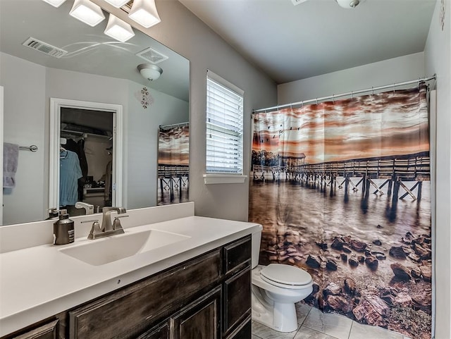 3529 Slate River Dr, Yukon, OK 73099 - full bathroom with vanity, tile patterned flooring, and a walk in closet