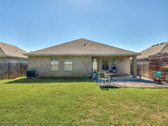 3529 Slate River Dr, Yukon, OK 73099 - rear view of house featuring a patio area, a fenced backyard, roof with shingles, and brick siding