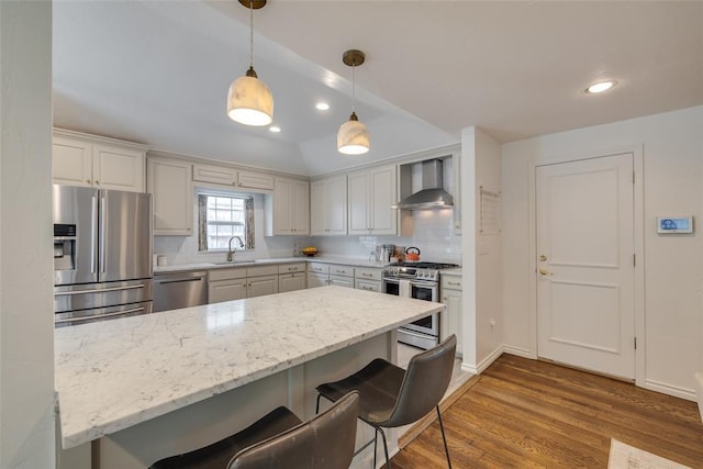 1114 Glenwood Ave, Nichols Hills, OK 73116 - kitchen featuring stainless steel appliances, wall chimney range hood, tasteful backsplash, wood finished floors, and recessed lighting