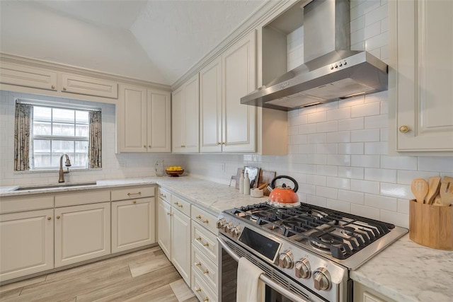 1114 Glenwood Ave, Nichols Hills, OK 73116 - kitchen featuring wall chimney range hood, stainless steel gas stove, vaulted ceiling, and backsplash
