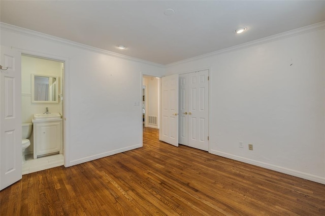 1114 Glenwood Ave, Nichols Hills, OK 73116 - unfurnished bedroom with wood finished floors, crown molding, and connected bathroom