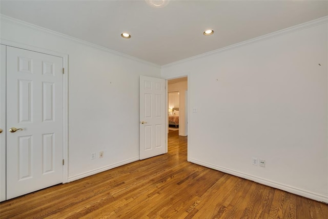 1114 Glenwood Ave, Nichols Hills, OK 73116 - unfurnished bedroom with wood finished floors, recessed lighting, and ornamental molding