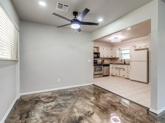 3013 Beverly Dr, Edmond, OK 73013 - kitchen with stainless steel appliances, ceiling fan, dark countertops, white cabinets, and recessed lighting