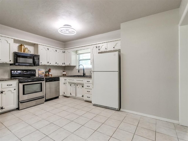 3013 Beverly Dr, Edmond, OK 73013 - kitchen featuring appliances with stainless steel finishes, dark countertops, white cabinets, and decorative backsplash