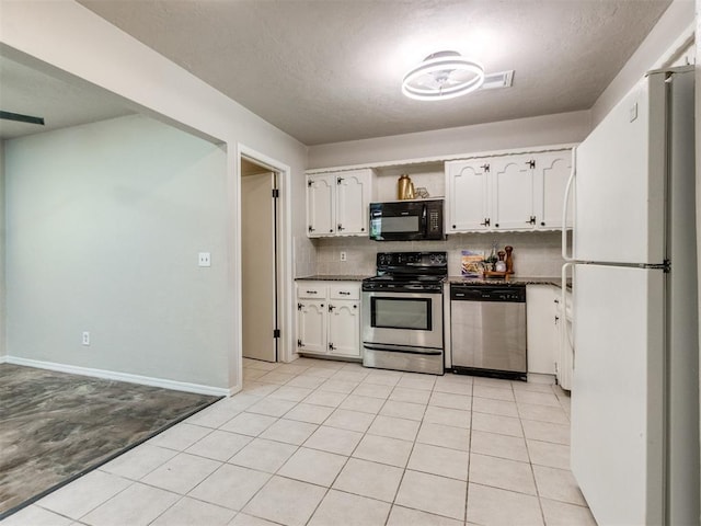 3013 Beverly Dr, Edmond, OK 73013 - kitchen with stainless steel appliances, white cabinets, dark countertops, backsplash, and light tile patterned floors