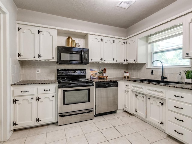 3013 Beverly Dr, Edmond, OK 73013 - kitchen featuring appliances with stainless steel finishes, white cabinetry, backsplash, dark stone counters, and light tile patterned floors