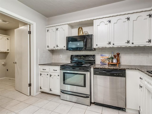 3013 Beverly Dr, Edmond, OK 73013 - kitchen with stainless steel appliances, dark stone counters, decorative backsplash, and white cabinets