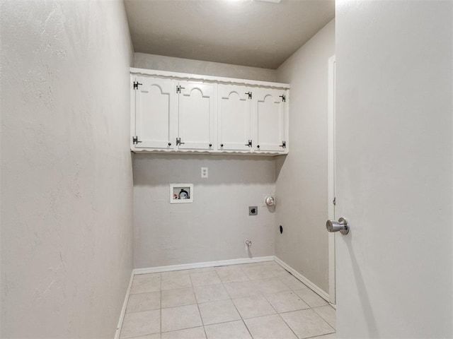3013 Beverly Dr, Edmond, OK 73013 - laundry area with cabinet space, hookup for an electric dryer, hookup for a gas dryer, washer hookup, and light tile patterned floors
