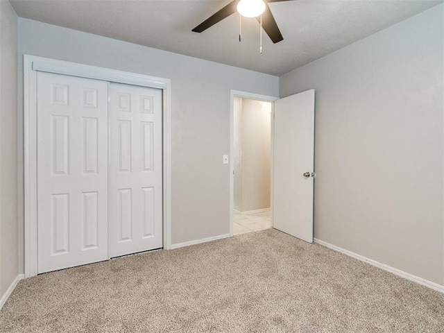 3013 Beverly Dr, Edmond, OK 73013 - unfurnished bedroom featuring light carpet, a closet, and a ceiling fan