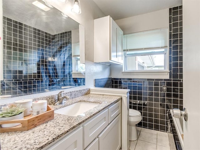 3013 Beverly Dr, Edmond, OK 73013 - full bathroom featuring tile patterned flooring, vanity, tile walls, and a bath