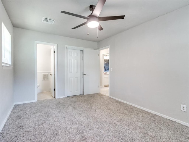 3013 Beverly Dr, Edmond, OK 73013 - unfurnished bedroom featuring light colored carpet, connected bathroom, a closet, and ceiling fan