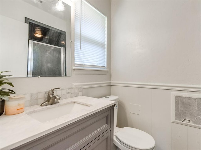 3013 Beverly Dr, Edmond, OK 73013 - bathroom featuring a stall shower, vanity, and wainscoting