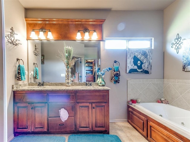 bathroom featuring double vanity and a tub with jets