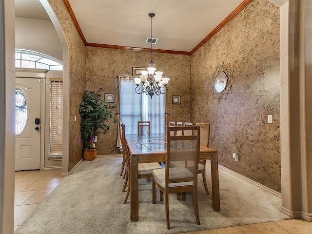 tiled dining area with arched walkways, a chandelier, crown molding, and carpet floors