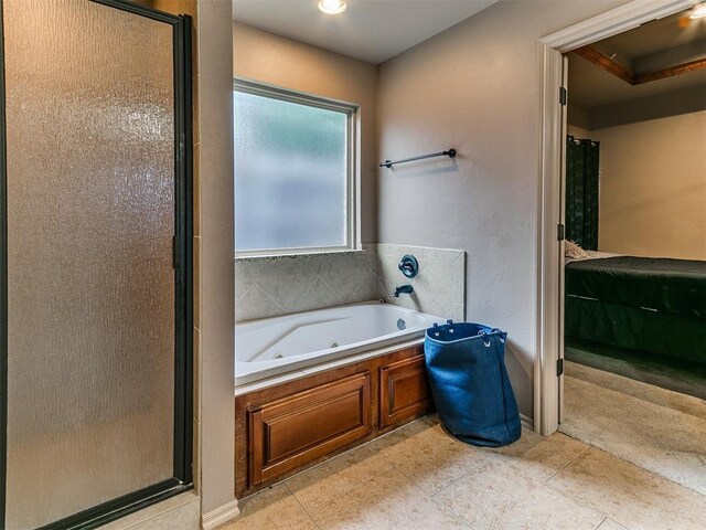 ensuite bathroom featuring a stall shower, a tub with jets, and tile patterned flooring