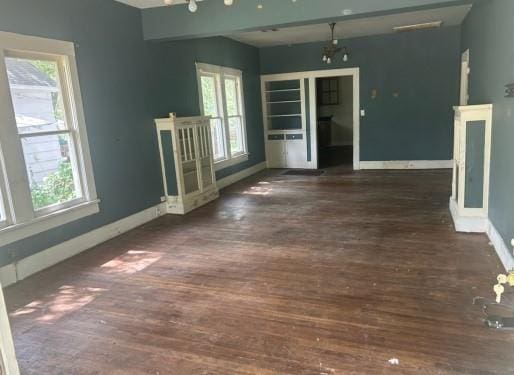 1217 W Main St, Ardmore, OK 73401 - spare room featuring healthy amount of natural light and wood finished floors