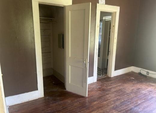 1217 W Main St, Ardmore, OK 73401 - unfurnished bedroom with wood finished floors and a closet