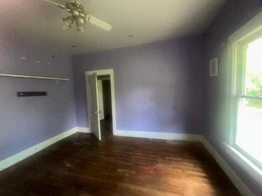 1217 W Main St, Ardmore, OK 73401 - empty room with wood finished floors and baseboards