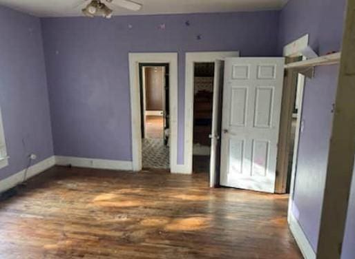 1217 W Main St, Ardmore, OK 73401 - unfurnished bedroom featuring wood finished floors and baseboards