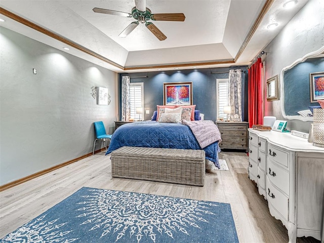 1521 Spring Creek Dr, Yukon, OK 73099 - bedroom with light wood-style floors, multiple windows, a raised ceiling, and ceiling fan