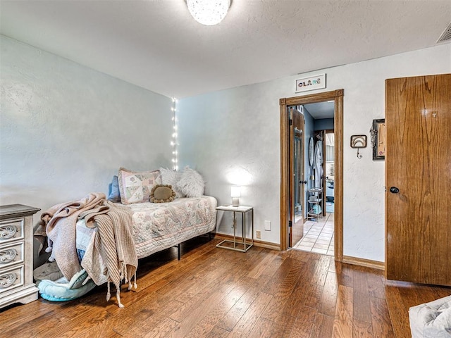 1521 Spring Creek Dr, Yukon, OK 73099 - bedroom featuring wood-type flooring and baseboards