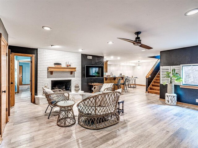 1521 Spring Creek Dr, Yukon, OK 73099 - living area featuring a ceiling fan, stairs, a brick fireplace, light wood-type flooring, and recessed lighting