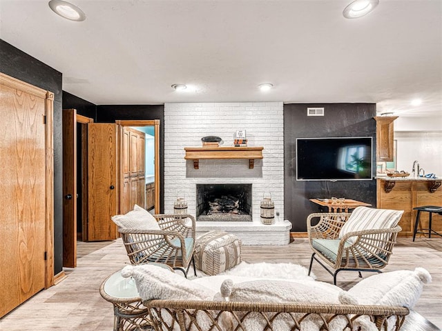 1521 Spring Creek Dr, Yukon, OK 73099 - living room with a brick fireplace, light wood finished floors, and recessed lighting