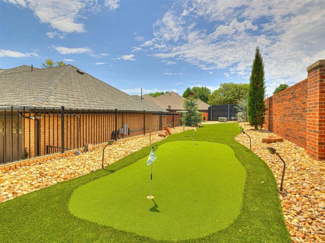 1521 Spring Creek Dr, Yukon, OK 73099 - fenced backyard with an area to practice putting