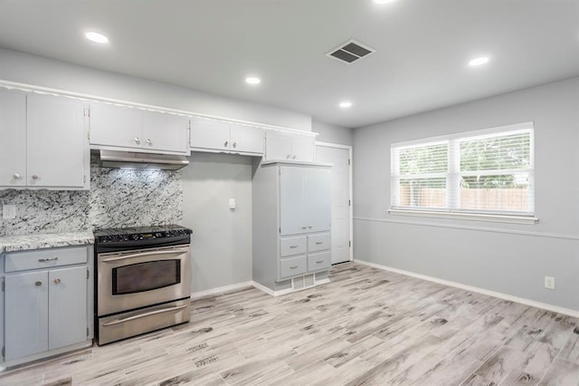 27 NE 65th St, Oklahoma City, OK 73105 - kitchen featuring stainless steel electric stove, under cabinet range hood, light wood-style floors, decorative backsplash, and recessed lighting