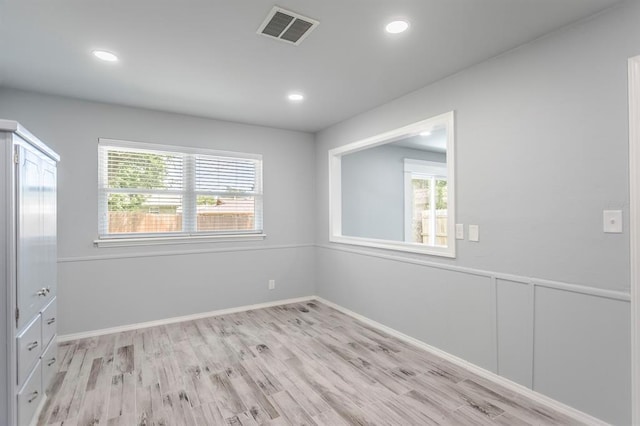 27 NE 65th St, Oklahoma City, OK 73105 - unfurnished bedroom featuring multiple windows, light wood-style floors, and recessed lighting