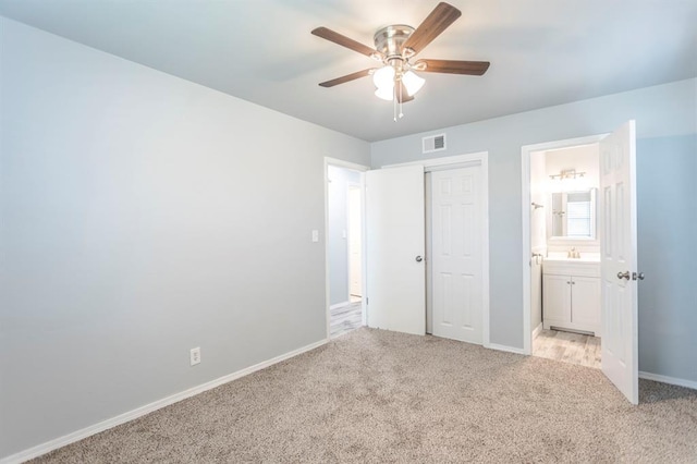 27 NE 65th St, Oklahoma City, OK 73105 - unfurnished bedroom with light carpet, a closet, ensuite bathroom, and a ceiling fan